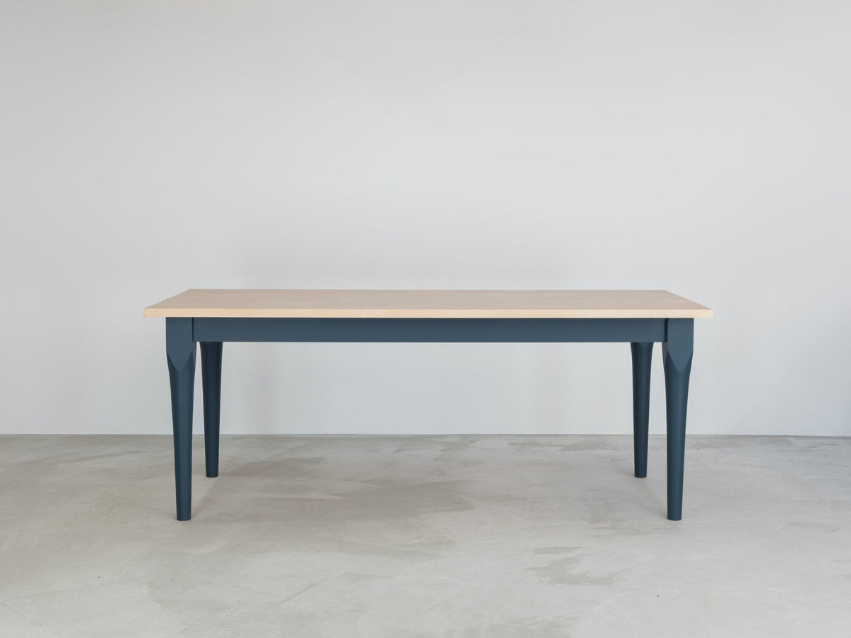 The Folde dining table with a Poplar Edge Grain Ply top and dark painted legs